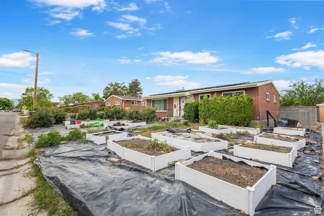 3466 W 4305 S, West Valley City, UT 84119 - view of front of home with a garden, roof mounted solar panels, and brick siding