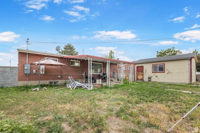 3466 W 4305 S, West Valley City, UT 84119 - rear view of house featuring brick siding and a lawn