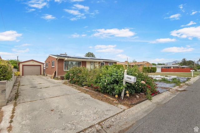 3466 W 4305 S, West Valley City, UT 84119 - single story home with brick siding, solar panels, an outdoor structure, concrete driveway, and a detached garage