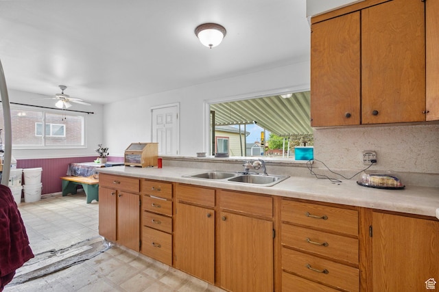 3466 W 4305 S, West Valley City, UT 84119 - kitchen featuring a sink, light flooring, light countertops, a ceiling fan, and brown cabinetry