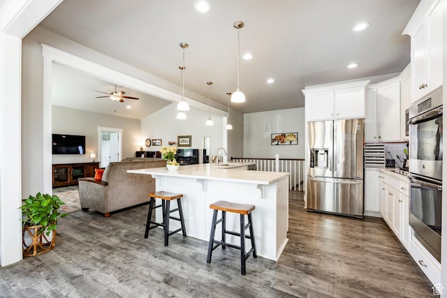 10352 S Sturgeon Dr W, South Jordan, UT 84009 - kitchen featuring appliances with stainless steel finishes, dark wood-type flooring, vaulted ceiling, a ceiling fan, and light countertops