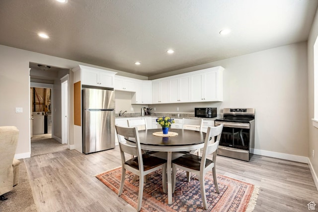 10352 S Sturgeon Dr W, South Jordan, UT 84009 - dining area with baseboards, light wood-style flooring, washer / dryer, and recessed lighting