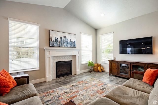 10352 S Sturgeon Dr W, South Jordan, UT 84009 - living area featuring lofted ceiling, a tile fireplace, wood finished floors, and baseboards