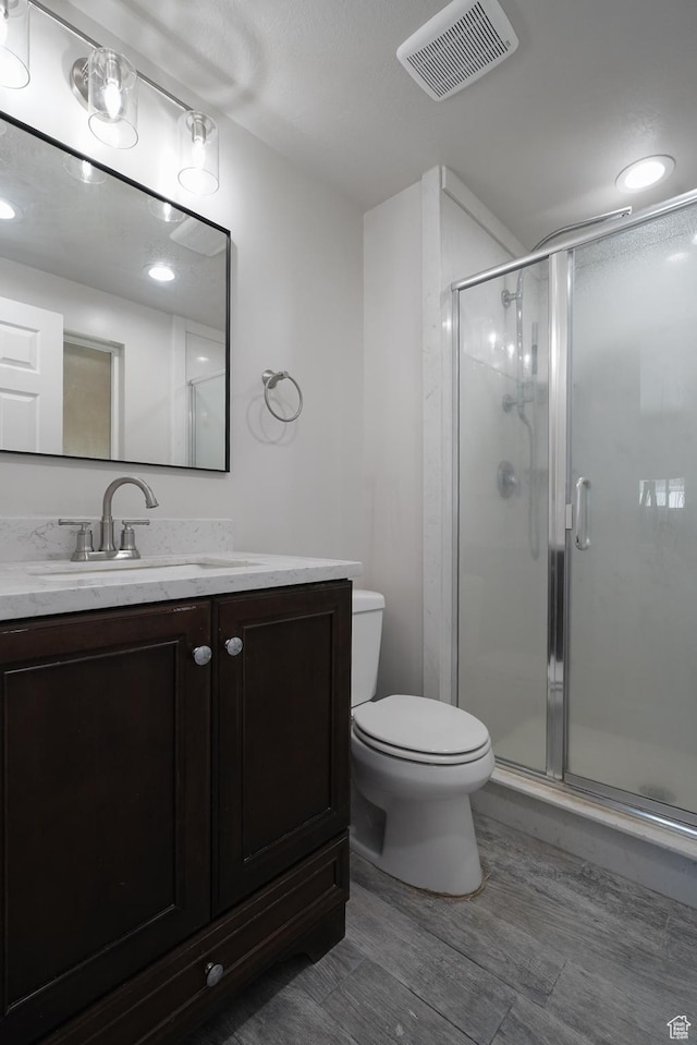 2612 S 8590 W, Magna, UT 84044 - bathroom featuring toilet, a shower stall, vanity, and wood finished floors