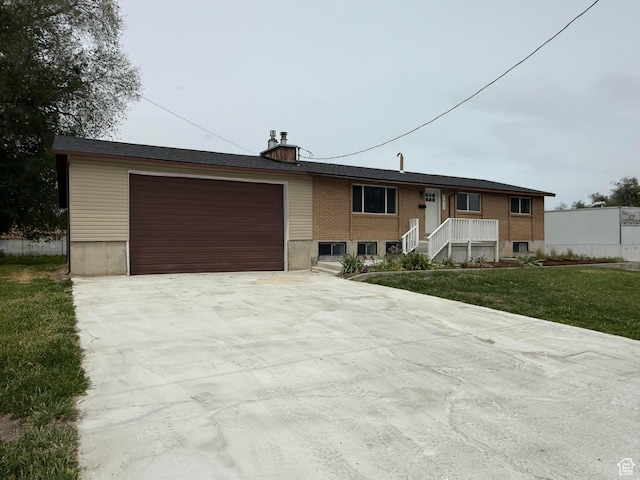 2612 S 8590 W, Magna, UT 84044 - view of front of house featuring concrete driveway, a front lawn, and an attached garage