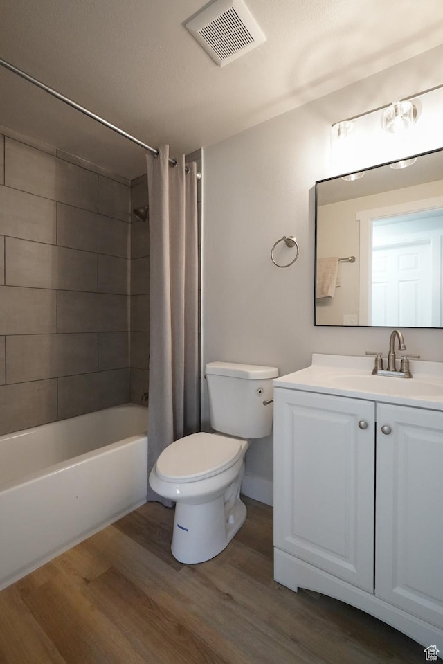 2612 S 8590 W, Magna, UT 84044 - full bathroom featuring wood finished floors, toilet, vanity, and shower / tub combo with curtain