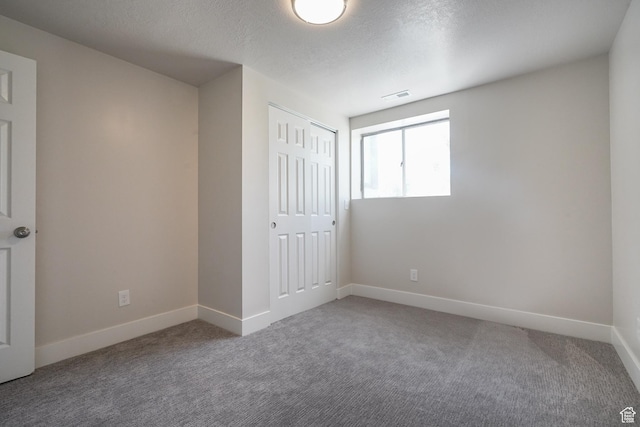 2612 S 8590 W, Magna, UT 84044 - unfurnished bedroom with carpet, baseboards, a closet, and a textured ceiling