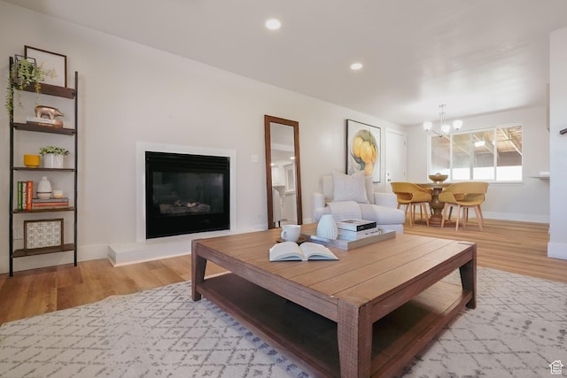 2612 S 8590 W, Magna, UT 84044 - living area featuring light wood-style flooring, a chandelier, baseboards, a glass covered fireplace, and recessed lighting