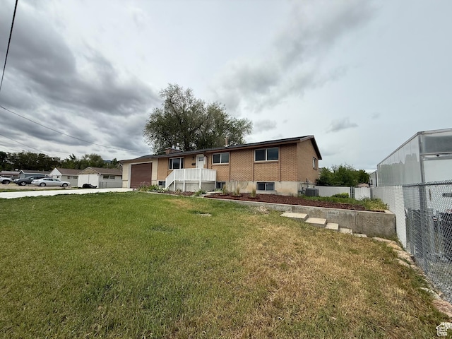 2612 S 8590 W, Magna, UT 84044 - view of front of home with an attached garage, concrete driveway, brick siding, and central air condition unit
