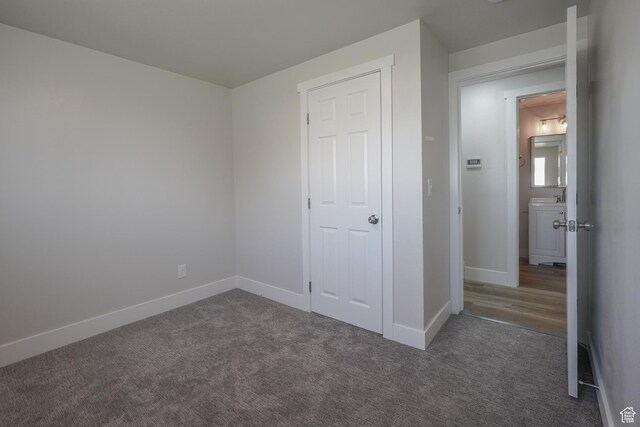 2612 S 8590 W, Magna, UT 84044 - unfurnished bedroom featuring dark carpet and baseboards