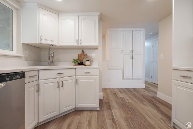 2612 S 8590 W, Magna, UT 84044 - kitchen with stainless steel dishwasher, light wood-style flooring, white cabinets, baseboards, and light countertops
