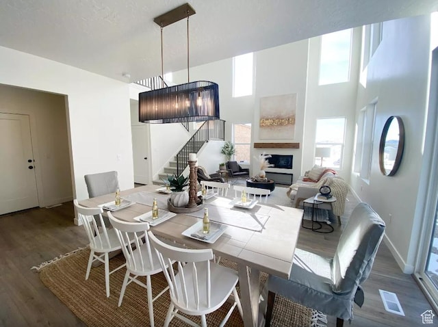 5894 N Canyon Rim Rd E Unit 621, Lehi, UT 84043 - dining room featuring stairway, wood finished floors, healthy amount of natural light, baseboards, and a high ceiling