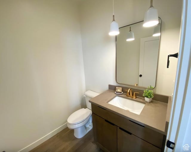 5894 N Canyon Rim Rd E Unit 621, Lehi, UT 84043 - half bathroom with wood finished floors, vanity, toilet, and baseboards
