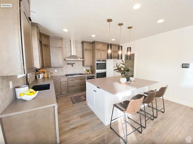 5894 N Canyon Rim Rd E Unit 621, Lehi, UT 84043 - kitchen featuring wall chimney exhaust hood, appliances with stainless steel finishes, a sink, light wood-style flooring, and decorative backsplash