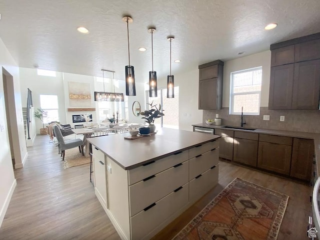 5894 N Canyon Rim Rd E Unit 621, Lehi, UT 84043 - kitchen with a sink, light wood-style floors, tasteful backsplash, a kitchen island, and recessed lighting