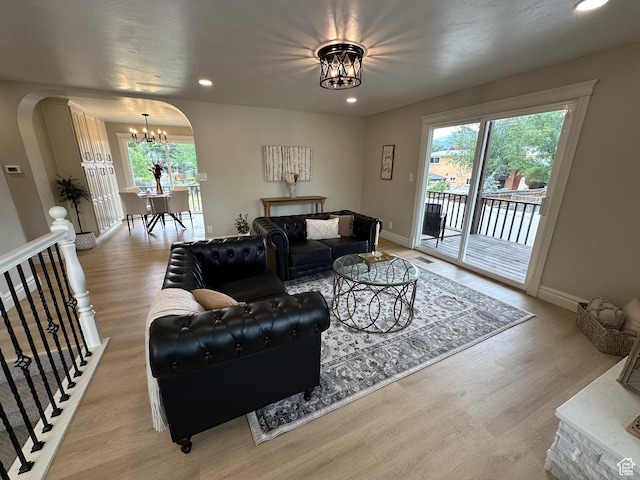 1391 E Mccormick Way, Cottonwood Heights, UT 84121 - living room featuring a chandelier, arched walkways, light wood-style flooring, plenty of natural light, and recessed lighting
