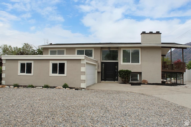 1391 E Mccormick Way, Cottonwood Heights, UT 84121 - raised ranch with a chimney, concrete driveway, a garage, and stucco siding