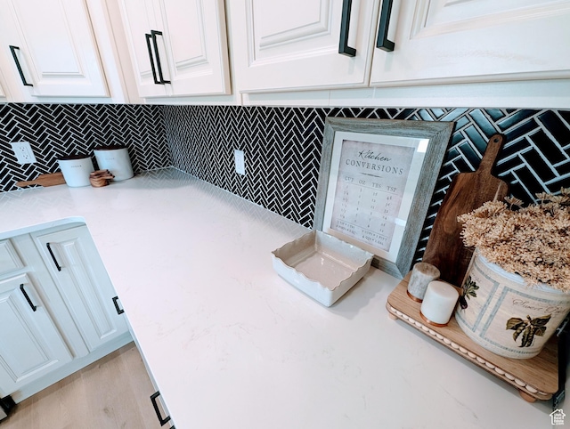 1391 E Mccormick Way, Cottonwood Heights, UT 84121 - kitchen view of white cabinetry, backsplash, and light stone countertops