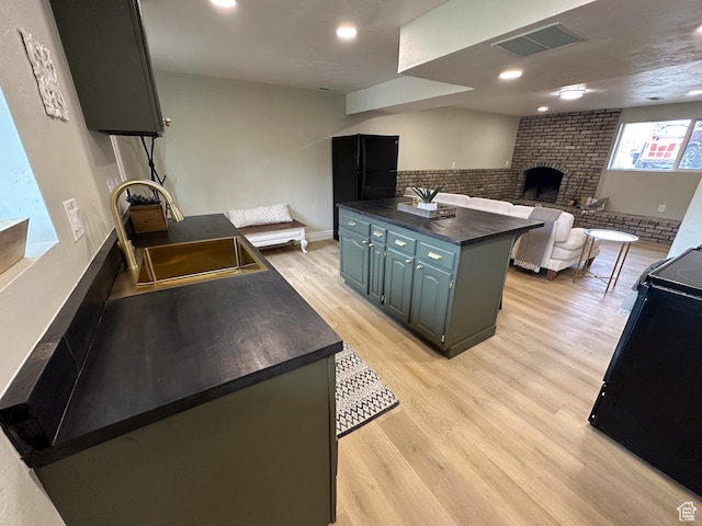 1391 E Mccormick Way, Cottonwood Heights, UT 84121 - kitchen with dark countertops, black range, a sink, light wood-style floors, and open floor plan