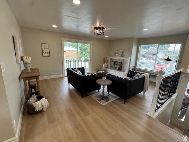 1391 E Mccormick Way, Cottonwood Heights, UT 84121 - living area with light wood finished floors, a fireplace, recessed lighting, and baseboards