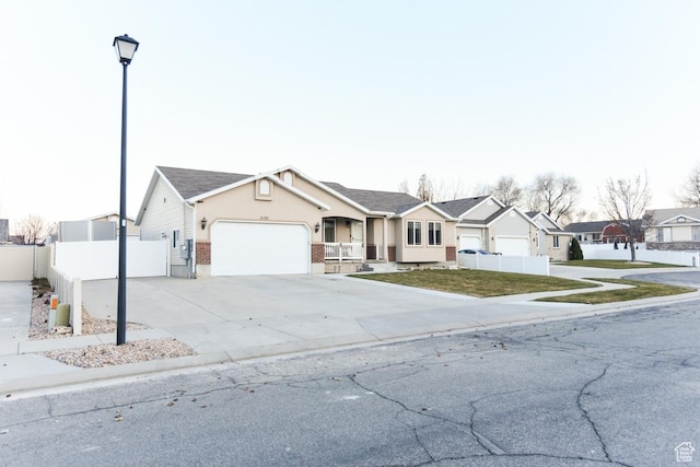 3155 S Autumn Blaze Cv W, West Valley City, UT 84128 - ranch-style house featuring a residential view, a garage, driveway, and stucco siding