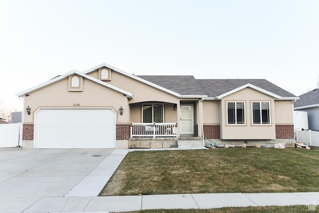 3155 S Autumn Blaze Cv W, West Valley City, UT 84128 - single story home featuring a porch, a garage, stucco siding, brick siding, and a front yard