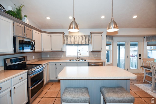 3155 S Autumn Blaze Cv W, West Valley City, UT 84128 - kitchen featuring appliances with stainless steel finishes, a sink, healthy amount of natural light, tasteful backsplash, and recessed lighting