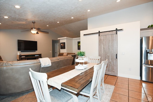 3155 S Autumn Blaze Cv W, West Valley City, UT 84128 - dining room with a barn door, recessed lighting, ceiling fan, light tile patterned floors, and vaulted ceiling