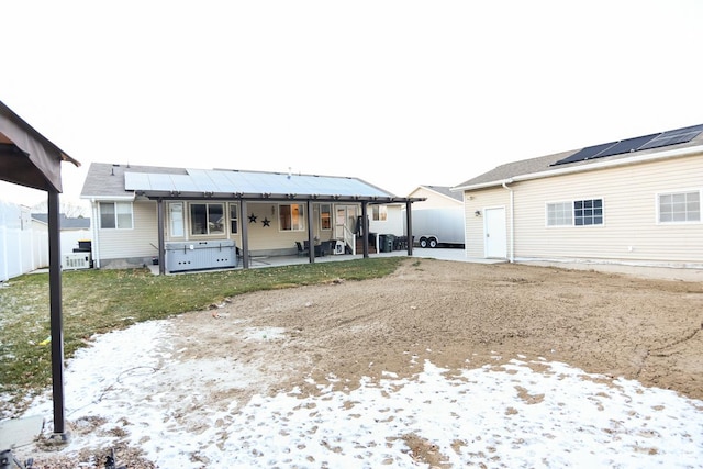 3155 S Autumn Blaze Cv W, West Valley City, UT 84128 - rear view of house with solar panels and a patio