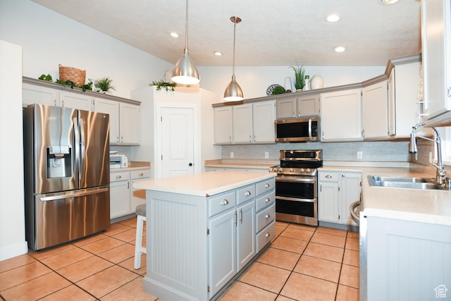 3155 S Autumn Blaze Cv W, West Valley City, UT 84128 - kitchen with stainless steel appliances, a sink, a center island, tasteful backsplash, and light tile patterned flooring