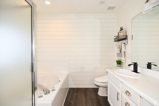 3155 S Autumn Blaze Cv W, West Valley City, UT 84128 - bathroom featuring a garden tub, wood finished floors, vanity, toilet, and recessed lighting