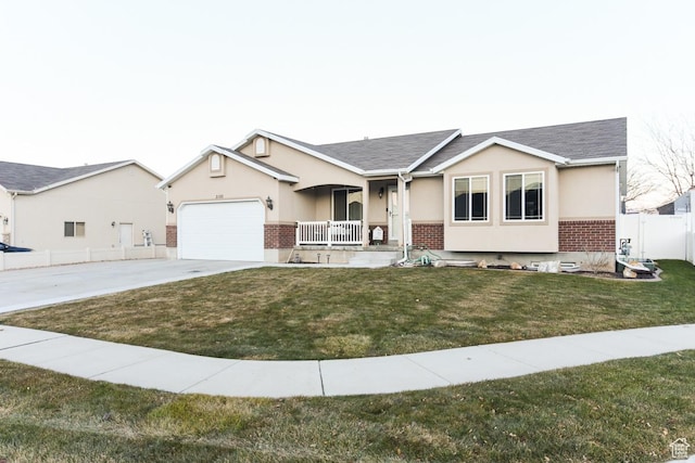 3155 S Autumn Blaze Cv W, West Valley City, UT 84128 - single story home with covered porch, brick siding, concrete driveway, and an attached garage