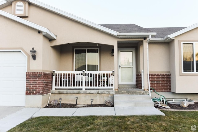 3155 S Autumn Blaze Cv W, West Valley City, UT 84128 - entrance to property with brick siding, a porch, stucco siding, a garage, and roof with shingles
