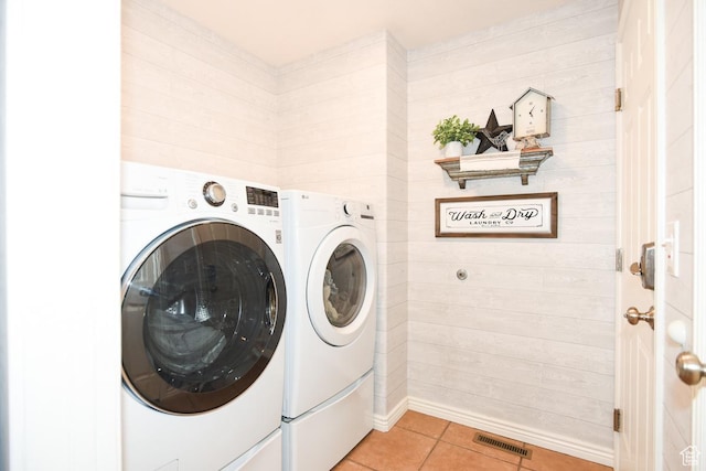 3155 S Autumn Blaze Cv W, West Valley City, UT 84128 - washroom with washing machine and clothes dryer, light tile patterned floors, and wooden walls