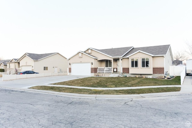 3155 S Autumn Blaze Cv W, West Valley City, UT 84128 - single story home with brick siding, driveway, a porch, an attached garage, and roof with shingles