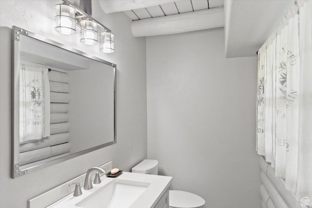 2899 W 8870 S, West Jordan, UT 84088 - bathroom featuring toilet, vanity, and beam ceiling