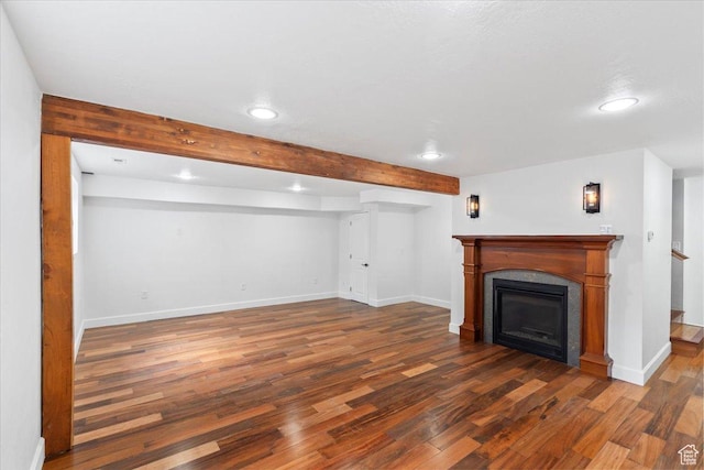 2899 W 8870 S, West Jordan, UT 84088 - unfurnished living room featuring recessed lighting, wood finished floors, baseboards, beam ceiling, and a glass covered fireplace