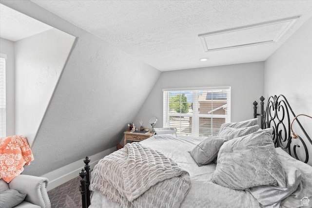 2899 W 8870 S, West Jordan, UT 84088 - carpeted bedroom featuring attic access, a textured ceiling, lofted ceiling, and baseboards