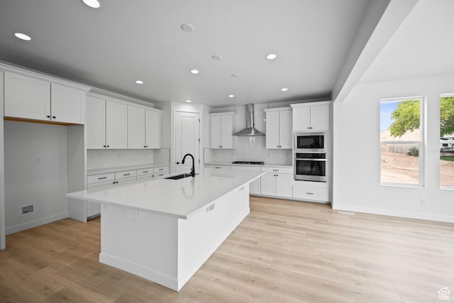 132 E Heron Ave S Unit 806, Saratoga Springs, UT 84045 - kitchen featuring a sink, wall chimney range hood, appliances with stainless steel finishes, recessed lighting, and tasteful backsplash