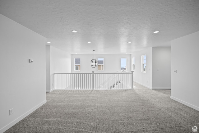 132 E Heron Ave S Unit 806, Saratoga Springs, UT 84045 - carpeted spare room with recessed lighting, baseboards, a textured ceiling, and a chandelier