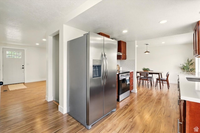 210 W 1 N, Preston, ID 83263 - kitchen with stainless steel appliances, baseboards, light wood-type flooring, backsplash, and recessed lighting