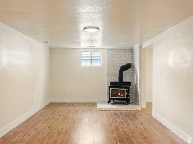 210 W 1 N, Preston, ID 83263 - unfurnished living room with wood finished floors, a wood stove, and baseboards