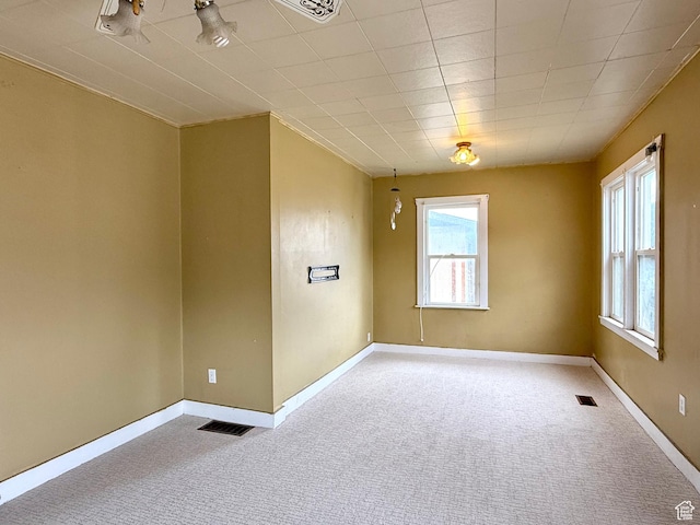 unfurnished room with carpet and baseboards