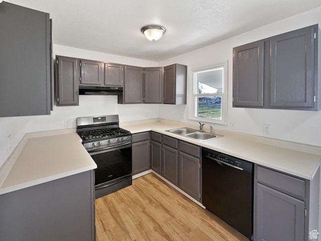 2959 W 1300 N, Clinton, UT 84015 - kitchen with gas range, a sink, black dishwasher, under cabinet range hood, and light wood finished floors