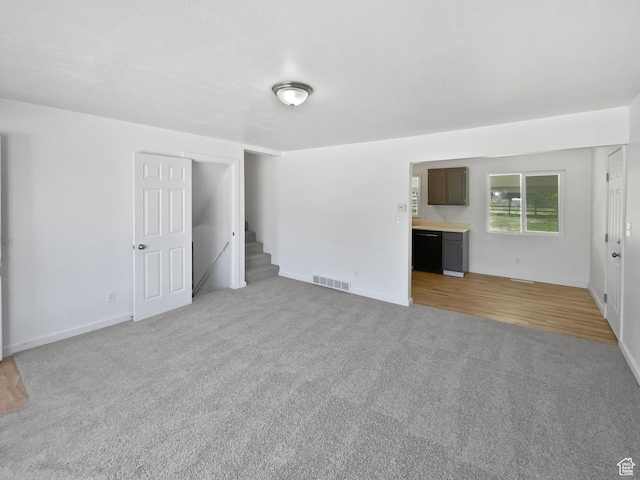 2959 W 1300 N, Clinton, UT 84015 - unfurnished living room featuring light carpet, stairs, and baseboards