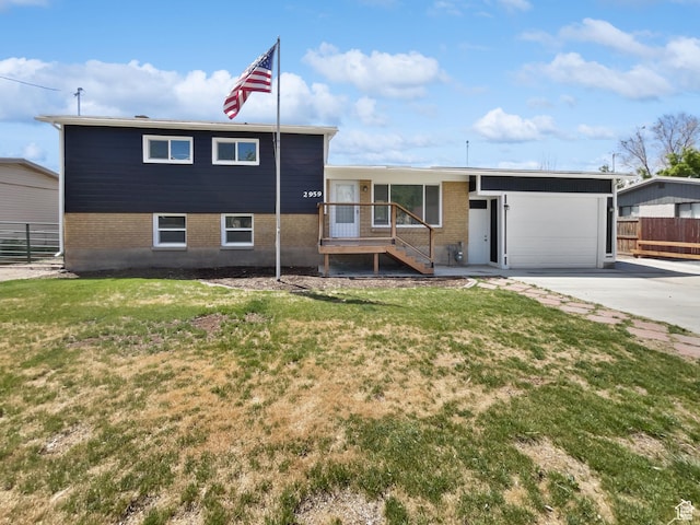 2959 W 1300 N, Clinton, UT 84015 - split level home featuring concrete driveway, brick siding, and a garage