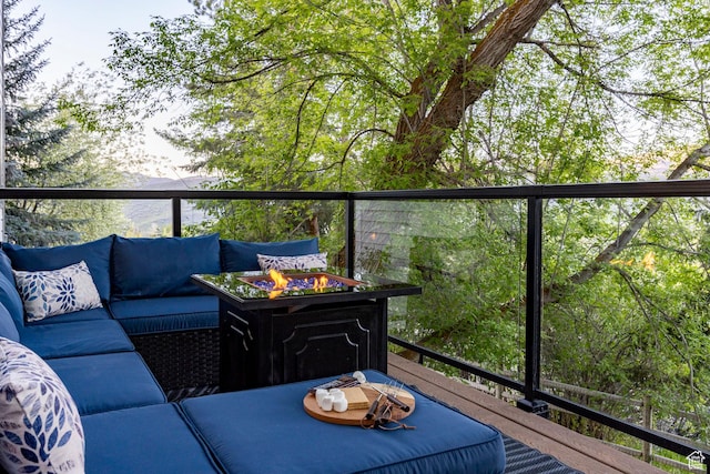 balcony with an outdoor living space with a fire pit