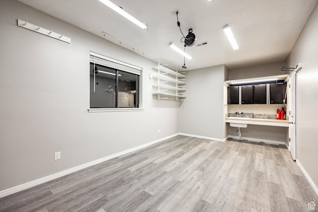 unfurnished room with light wood finished floors and baseboards