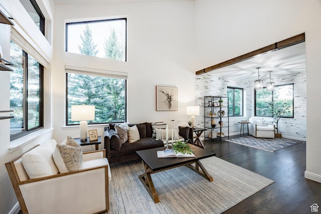 living room with wood finished floors and a high ceiling