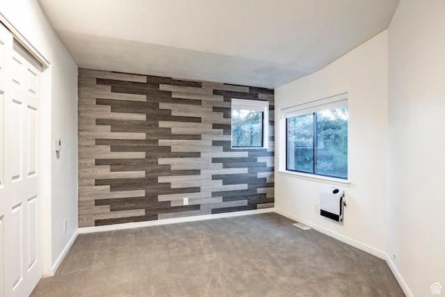 unfurnished room with carpet and baseboards